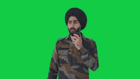 serious sikh indian army man giving instructions on walkie talkie green screen