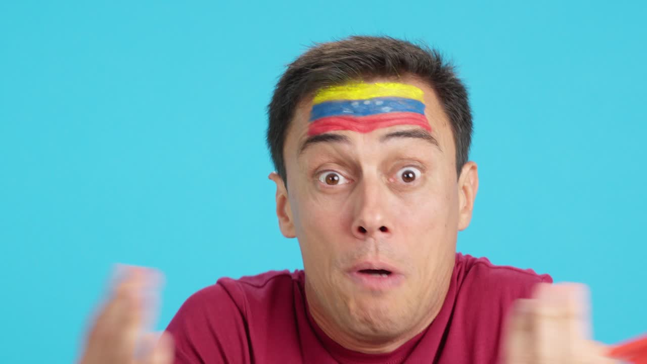 Man with venezuelan national flag upset with a referee