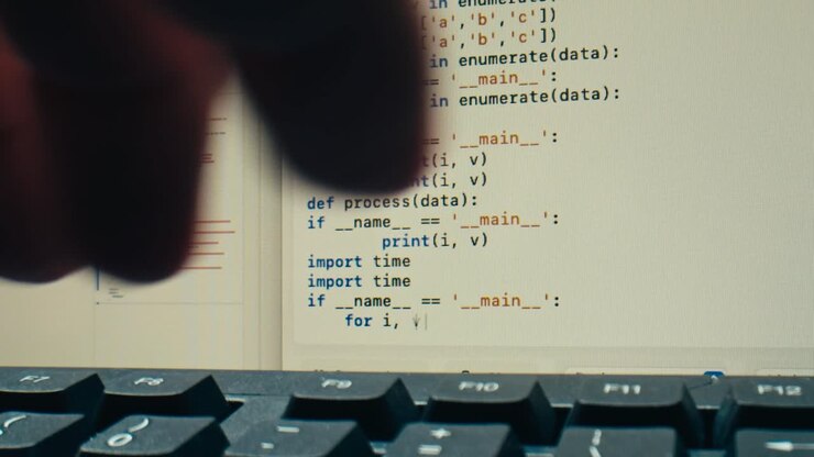 Close-up of Programming Code on Computer Screen with Keyboard