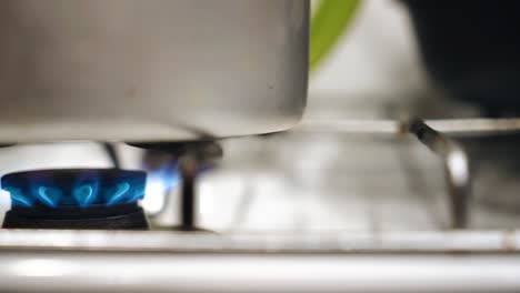 shooting a working gas stove in close-up. the flame from the burning gas is shown large