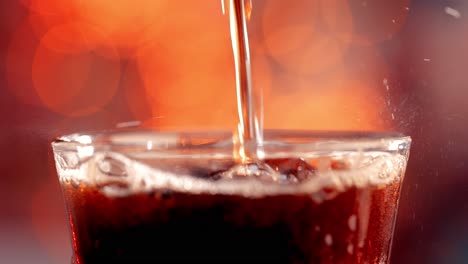 cola with splashing bubbles slow motion on a blurry light ,blurry background.