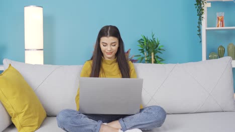 Young-businesswoman-typing-on-laptop-working-on-Internet-at-home