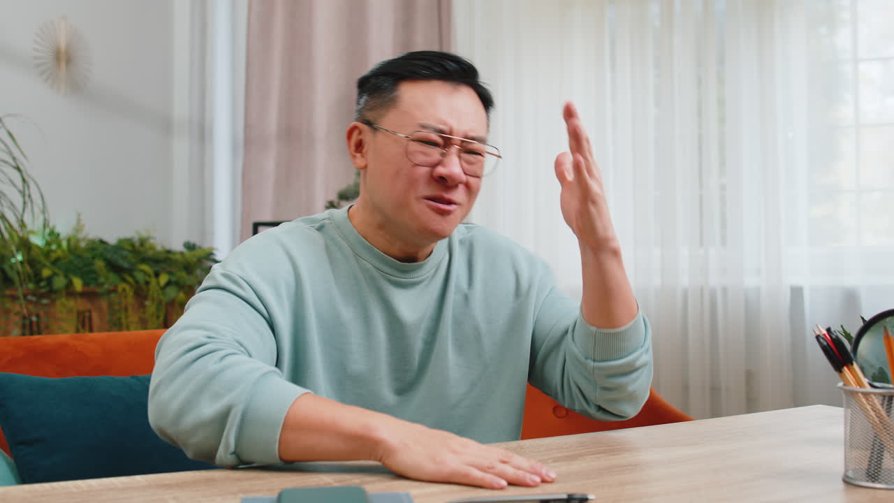 Aggressive asian man screams stress tension problems panic hopelessness fear surprise shock nervous