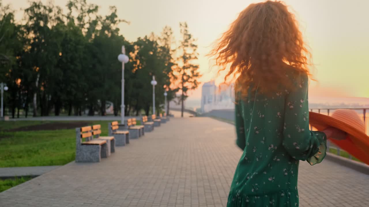 Woman enjoying a sunset walk in a park
