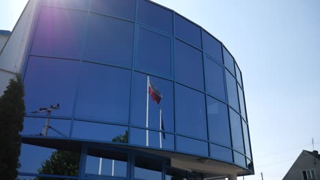 polish flag reflects in office building windows