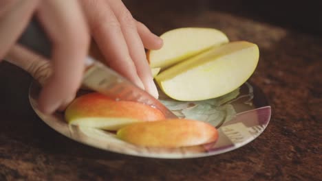 nutritious and healthy apple fruit being sliced with a paring knife