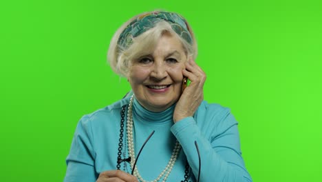 Elderly-stylish-caucasian-grandmother-woman-talking-on-mobile-phone.-Chroma-key