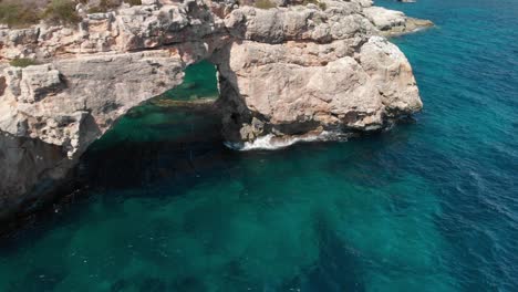 Spain-Mallorca-Cala-Llombards-and-Cala-Santanyi-at-4k-24fps-with-ND-filters-flying-with-a-DJI-Mavic-Air-with-beautiful-views-of-the-beaches,-rocks,-boats-and-blue-water