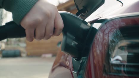 Close-up-of-electric-car-charging-in-parking-lot