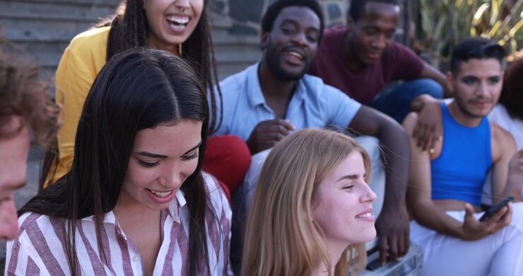 Diverse Group of Happy Young Friends Socializing and Laughing Outdoors
