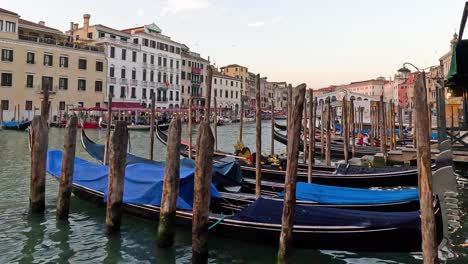 gondolas docked along a venice canal at sunset