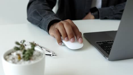 person using laptop and mouse