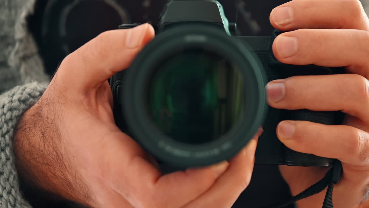 Close up of a man holding a professional camera