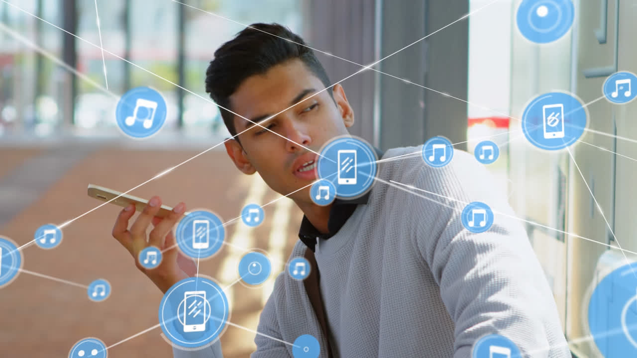 Animation of network of connections with icons over biracial businessman talking on smartphone