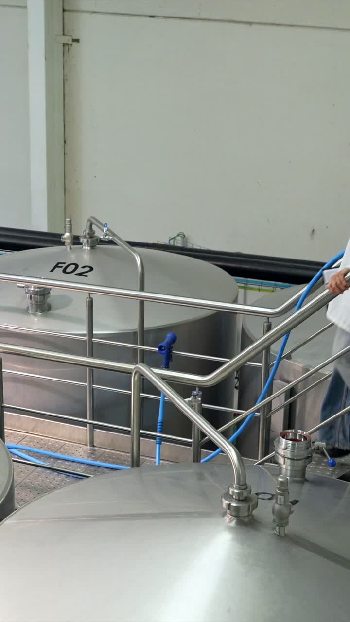 Scientist Inspecting Brewery Tanks