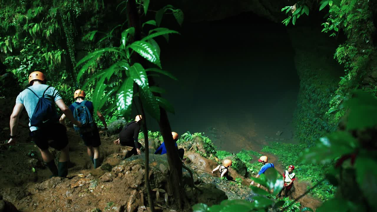 Group of people spelunking in a dark cave