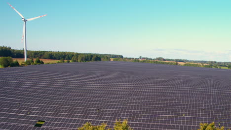 massive solar power plant and windmills aerial view