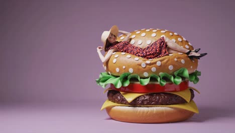 woman relaxing on a giant burger