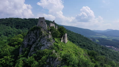 flight close to abandoned medieval ruined plavecky castle on a rock, slovakia