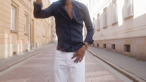 afro caribbean man with panama hat dancing in the street