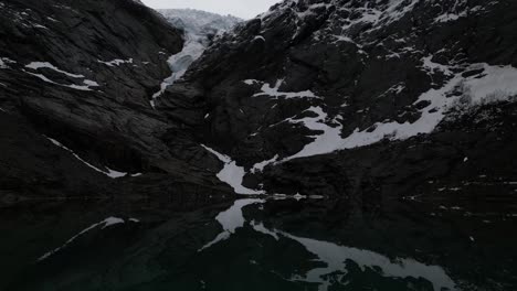 briksdalsbreen glacier great lake in norway. backward shot.