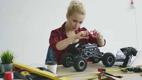 female repairing radio controlled car