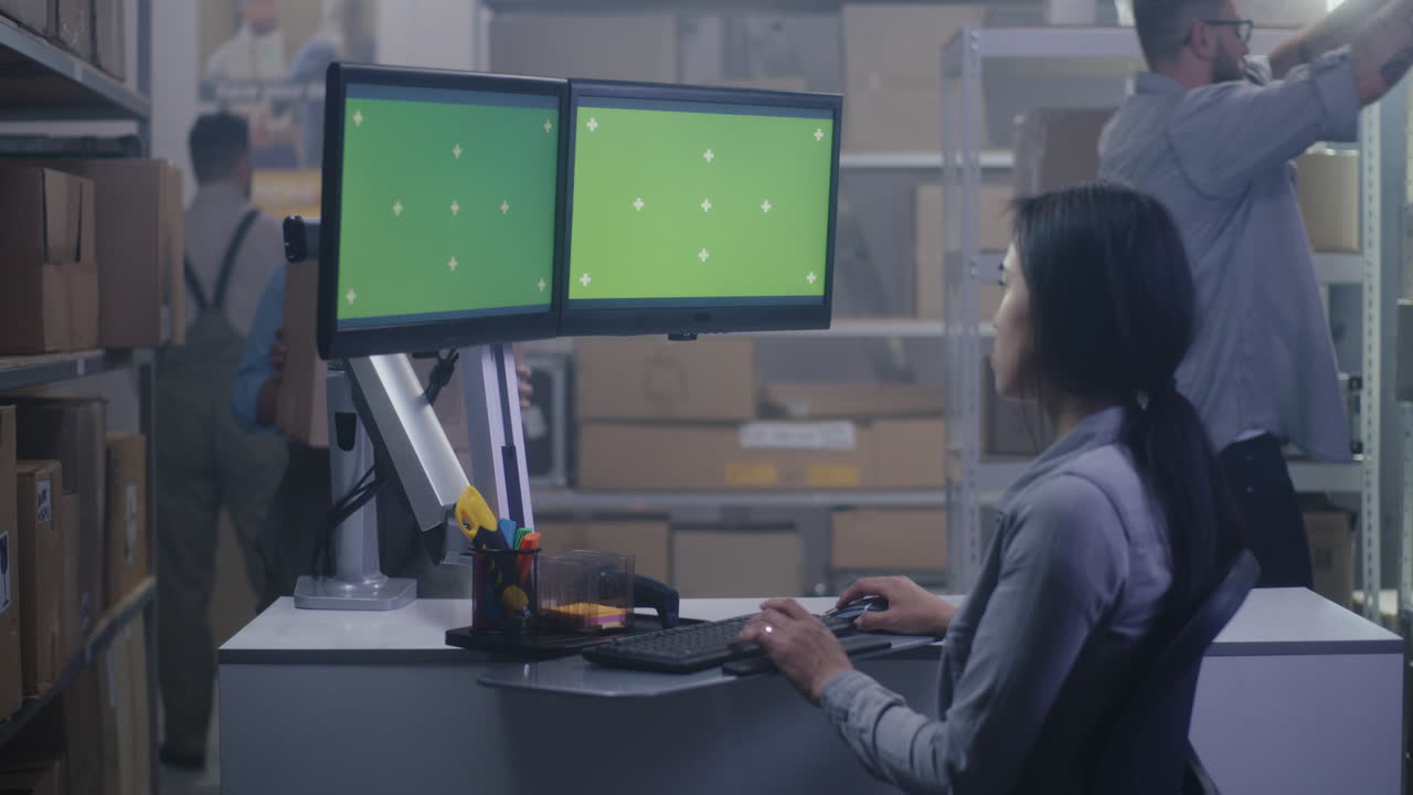 Warehouse Workers and Green Screen Monitors