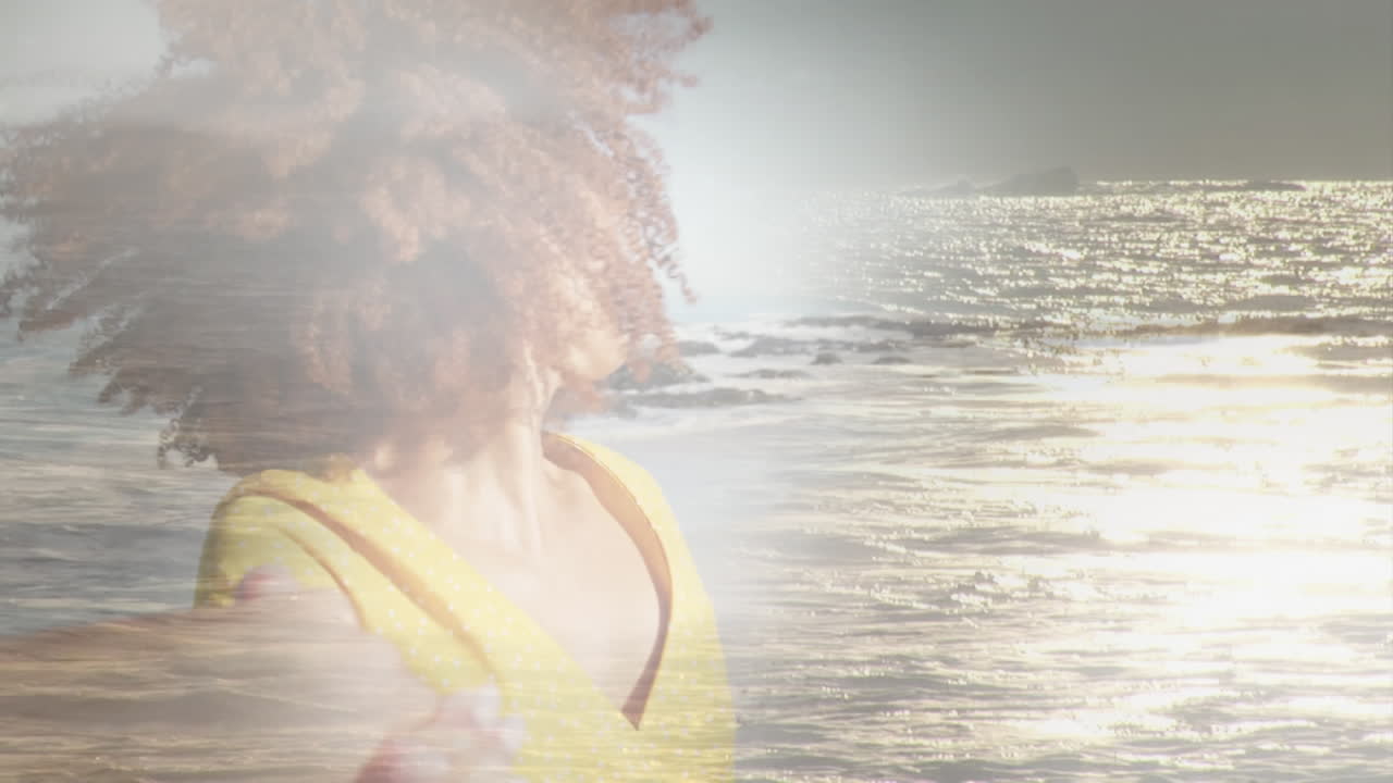 Animation of happy african american woman at beach over sun reflecting on sea