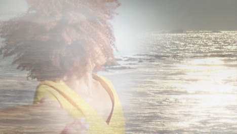 animation of happy african american woman at beach over sun reflecting on sea