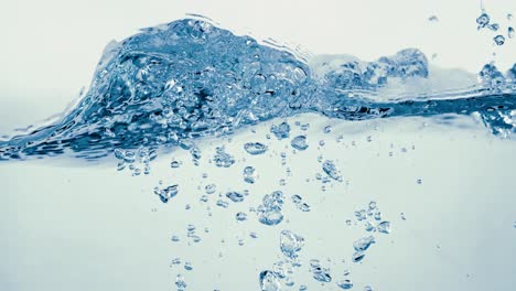 many bubbles in water close up, abstract water wave with bubbles in slow motion