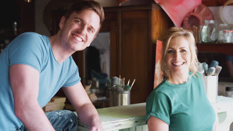 portrait of couple in workshop upcycling and working on craft projects