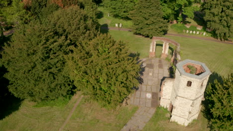 descending aerial shot over crumbling old church holy ghost cemetery basingstoke