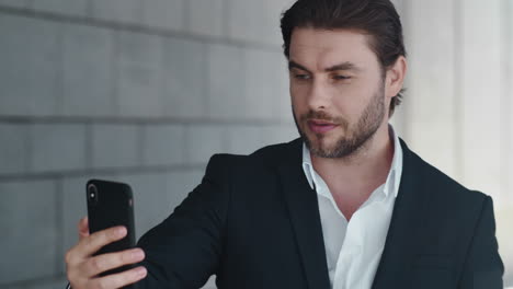 businessman talking online on street. man with cellphone working outdoors