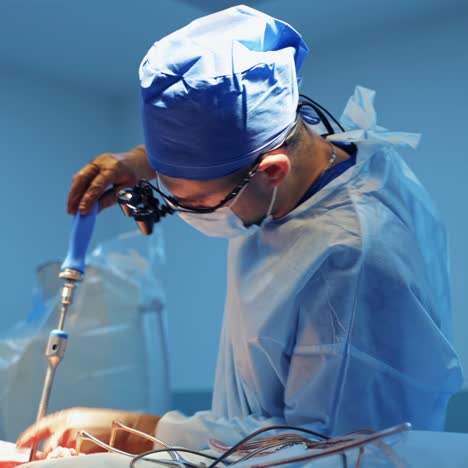 professional neurosurgeon in scrubs and surgery glasses uses special neurosurgery equipment. modern operaton room background