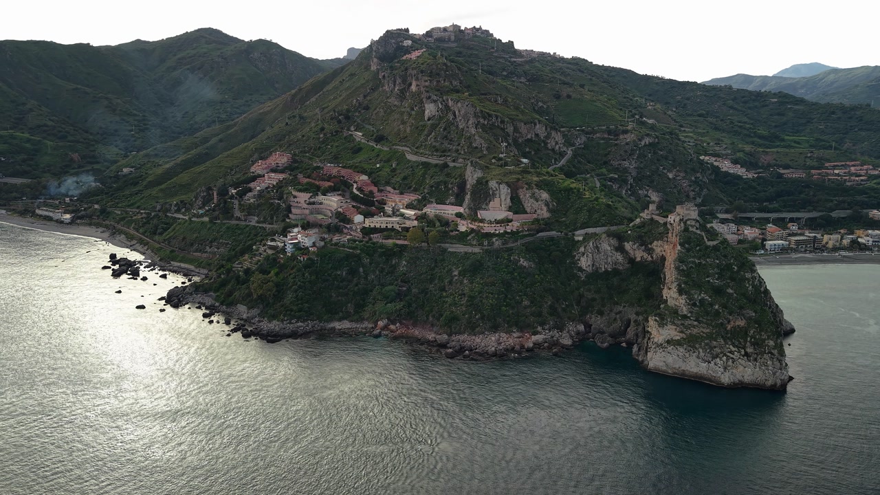 Aerial view of Sant'Alessio Castle in Sicily with rugged coastline