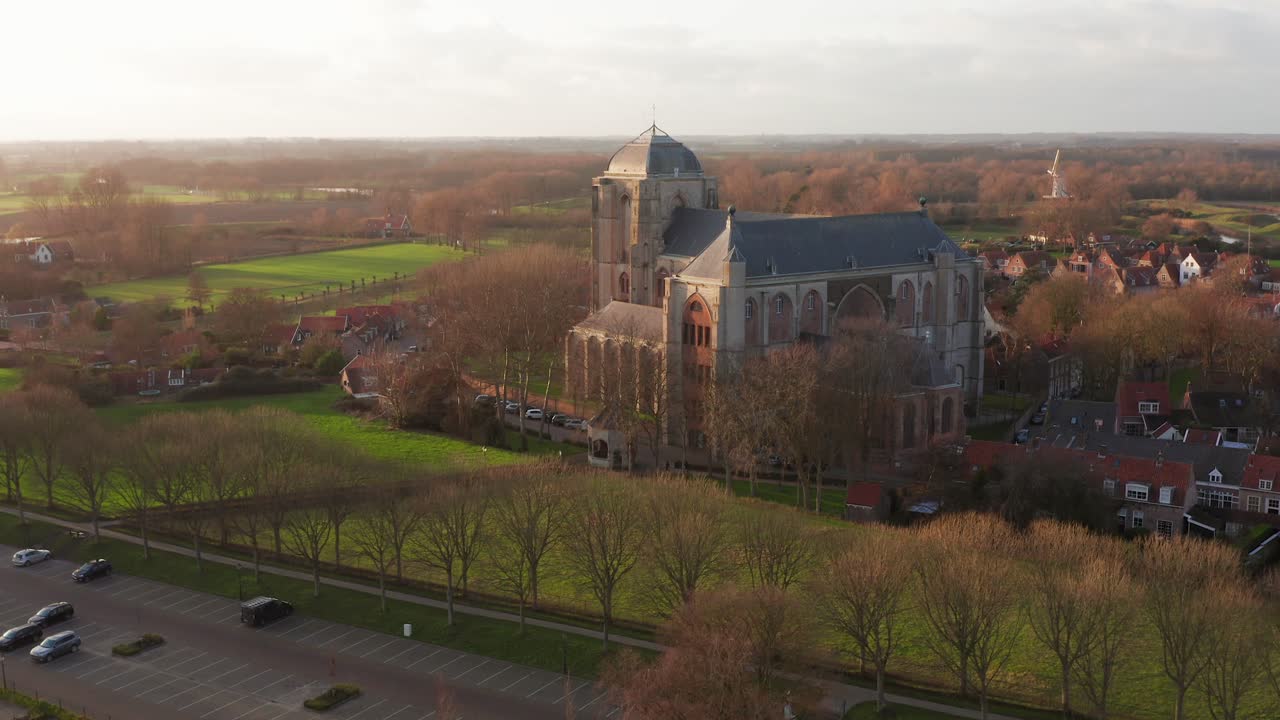 The big historical church in the touristic village Veere, located in a beautiful landscape. Drone shot