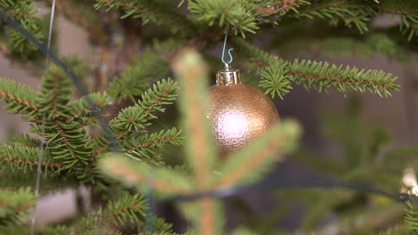 person hand place christmas tree toy on christmas tree