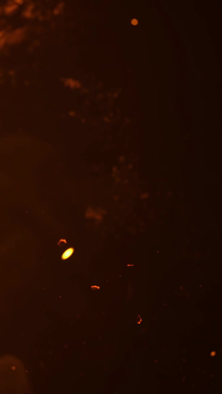 Warm light shines through the dark space causing small sparks to float