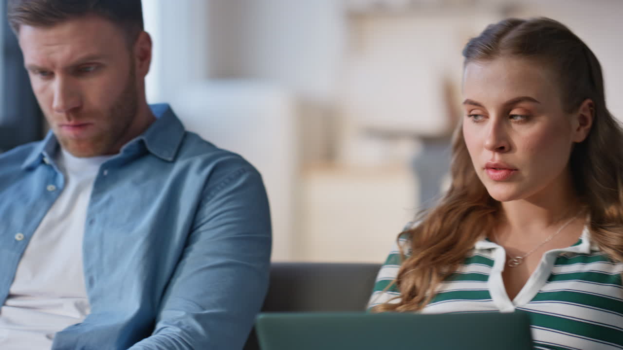 Husband wife working laptops sitting sofa together closeup. Couple remote work