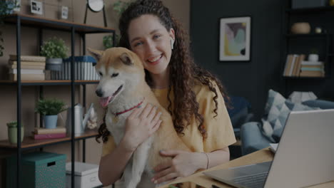 woman with shiba inu dog working from home