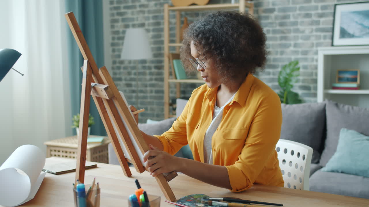 Young Woman Painting at Home