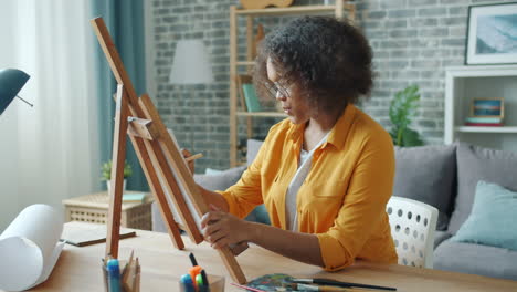 Young Woman Painting at Home