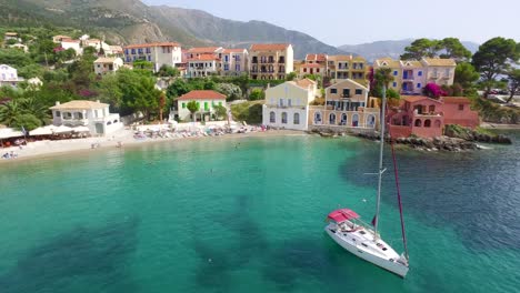 Aerial-drone-shot-panning-from-the-right-to-the-left-at-a-beachfront-of-a-secret-getaway-in-Agriosiko-Beach,-Kefalonia-island,-located-in-Western-Greece