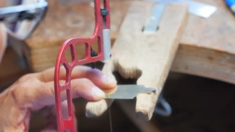 craftswoman using hacksaw