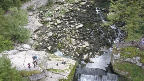 Waterfall-in-the-Doubs-River,-amazed-people,-forest-and-rocks