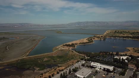 Aerial-view-of-shoreline-lake-and-Marsh-swamp-pan-left-front-view-low-tide