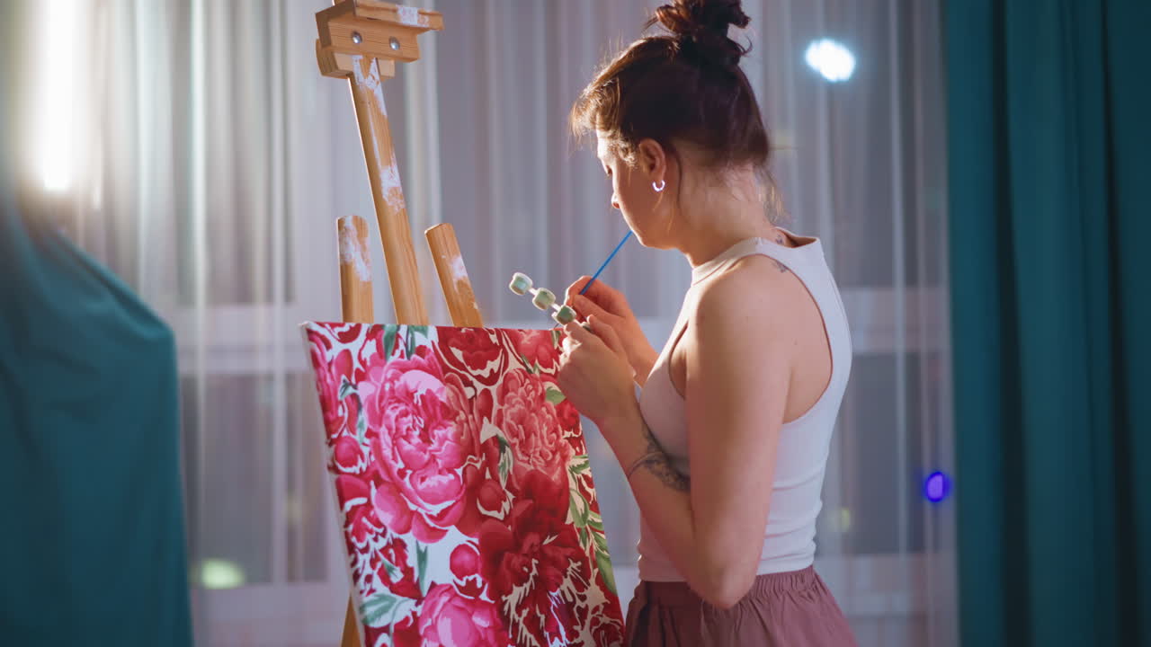 White Woman Adding Finishing Touches To Floral Canvas Before Exhibition, Careful Polish Of Layers And Edges, GalleryReady Composition Under Soft Curtain Light, Focused Creative Dedication