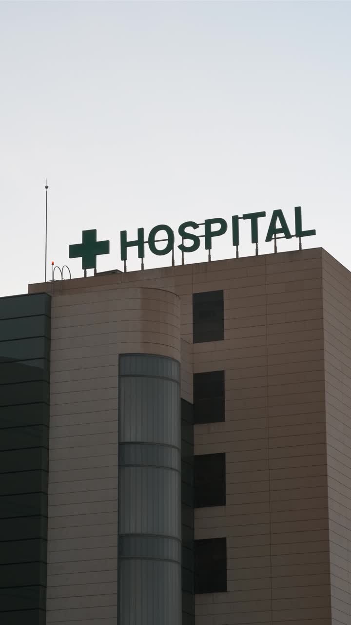 HOSPITAL sign in letters on the outside. Vertical video