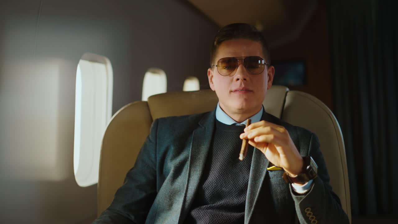 Man smoking cigar on private jet