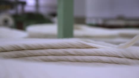 cotton weaving into thread at a textiles manufacturing plant